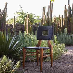 Charcoal dining chair with woven back, upholstered seat, and light wood legs