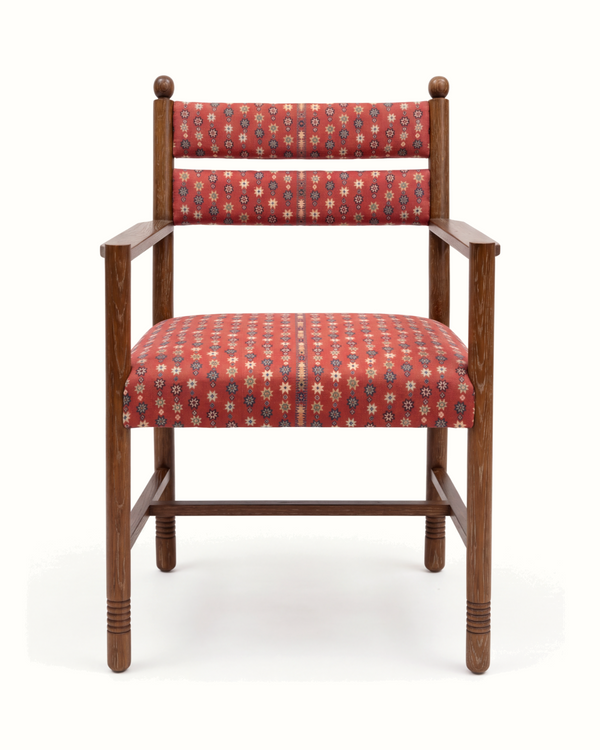 Upholstered armchair with red patterned fabric seat and back, light walnut wood frame