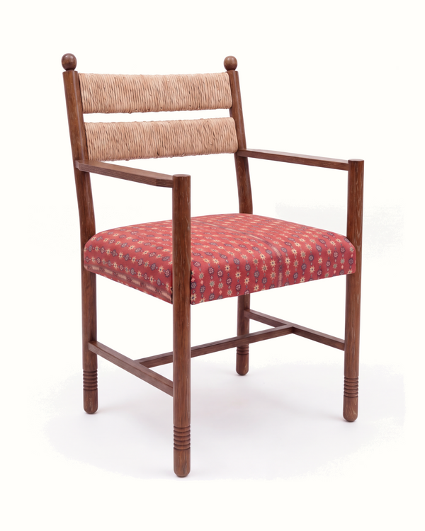 Upholstered armchair with rush back, dark wood arms, and red patterned seat