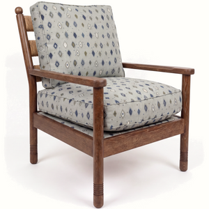 Wood lounge chair with blue diamond-pattern upholstered cushion and tall back panel