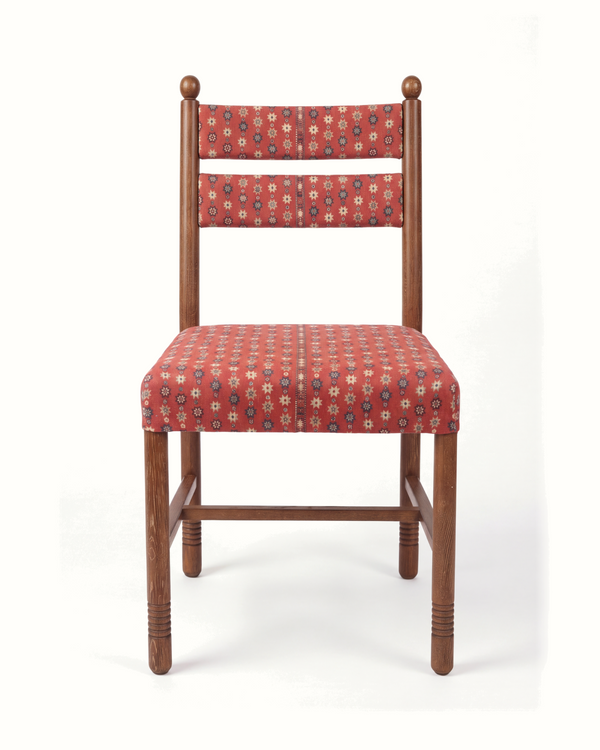 Upholstered dining chair with patterned red seat and back, dark wood frame