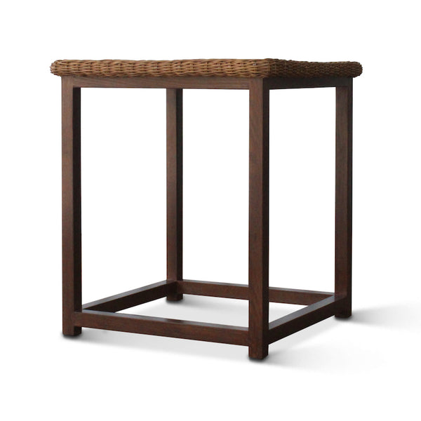 Dark walnut wicker side table from the side, showing woven top and open base.