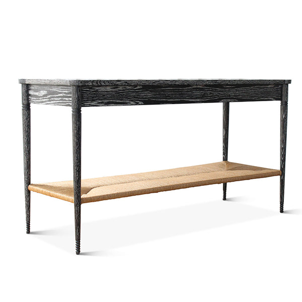 Black console table with woven paper rush bench shelf and four turned legs.