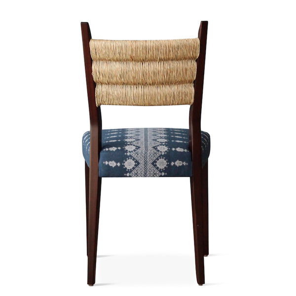 Our Silverlake side chair, designed by Hollywood at Home founder Peter Duhham, is handmade in Los Angeles with a solid oak frame, a handwoven rush back, and an upholstered seat. The dining chair adds vintage style to a dining area. 